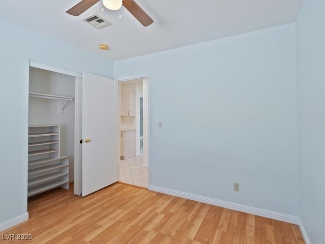 4323 Pageantry Falls Dr, North Las Vegas, NV 89031 - unfurnished bedroom with light wood-style floors, a closet, and a ceiling fan