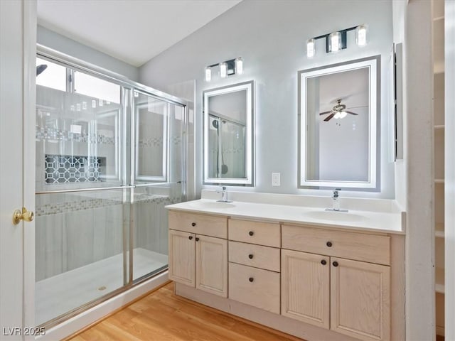 4323 Pageantry Falls Dr, North Las Vegas, NV 89031 - bathroom with a stall shower, double vanity, and wood finished floors
