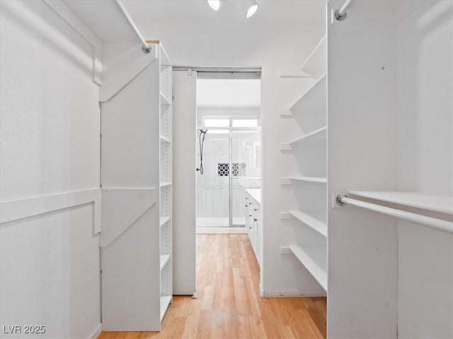 4323 Pageantry Falls Dr, North Las Vegas, NV 89031 - spacious closet featuring light wood-style floors