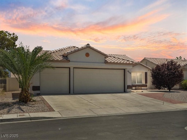 4323 Pageantry Falls Dr, North Las Vegas, NV 89031 - mediterranean / spanish-style house with a tiled roof, an attached garage, and concrete driveway