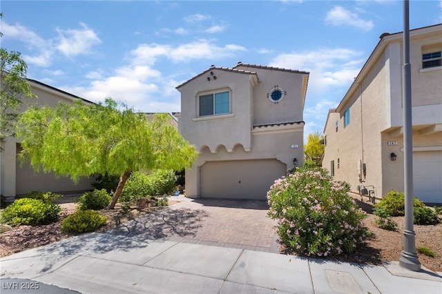 151 Duckhook Ave, Las Vegas, NV 89148 - mediterranean / spanish-style house featuring a garage, stucco siding, decorative driveway, and a tiled roof