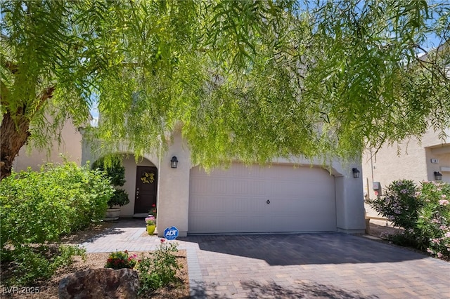151 Duckhook Ave, Las Vegas, NV 89148 - view of property hidden behind natural elements with stucco siding and decorative driveway