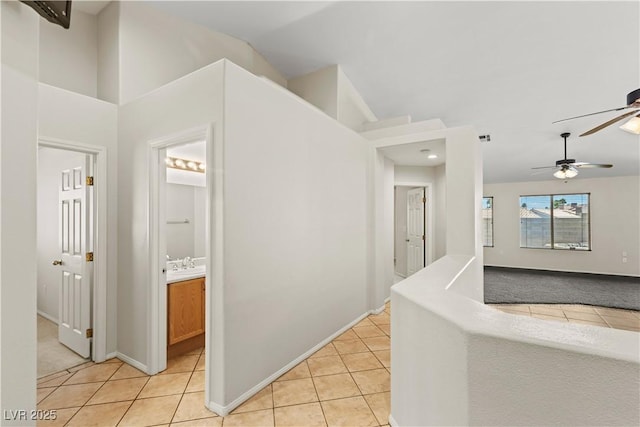 7825 White Grass Ave, Las Vegas, NV 89131 - hallway with light tile patterned floors and vaulted ceiling