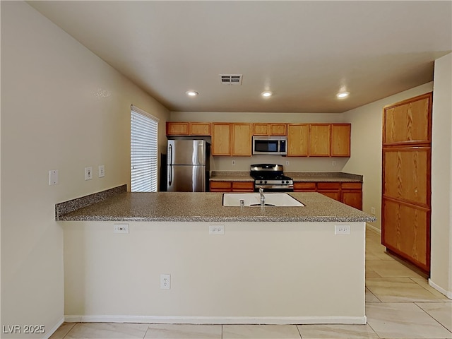 2132 Tierra Del Verde St, Las Vegas, NV 89156 - kitchen with stainless steel appliances, a peninsula, recessed lighting, and light tile patterned floors