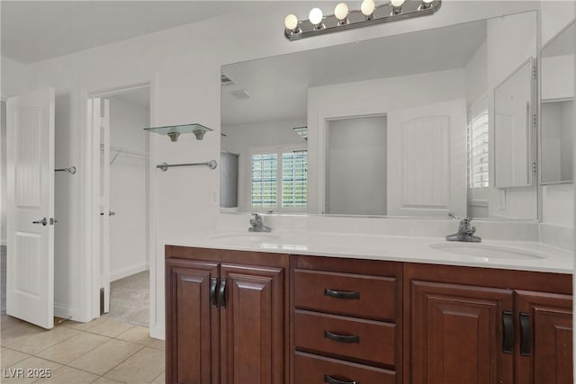 4036 W Bird Man Ln, North Las Vegas, NV 89084 - full bathroom with double vanity, tile patterned floors, and a spacious closet