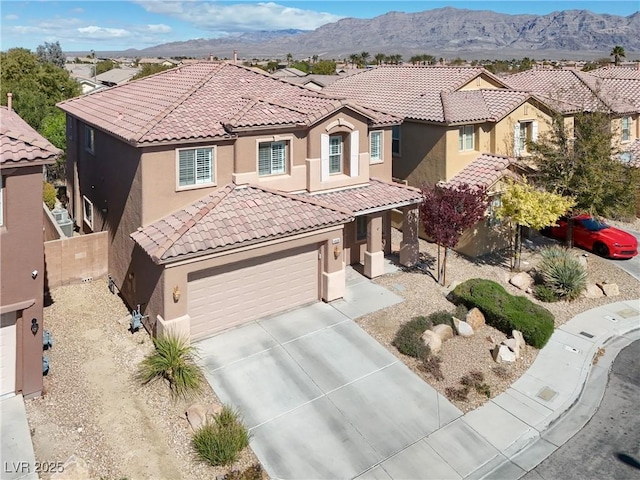 4036 W Bird Man Ln, North Las Vegas, NV 89084 - mediterranean / spanish-style house featuring stucco siding, a tile roof, concrete driveway, and a residential view