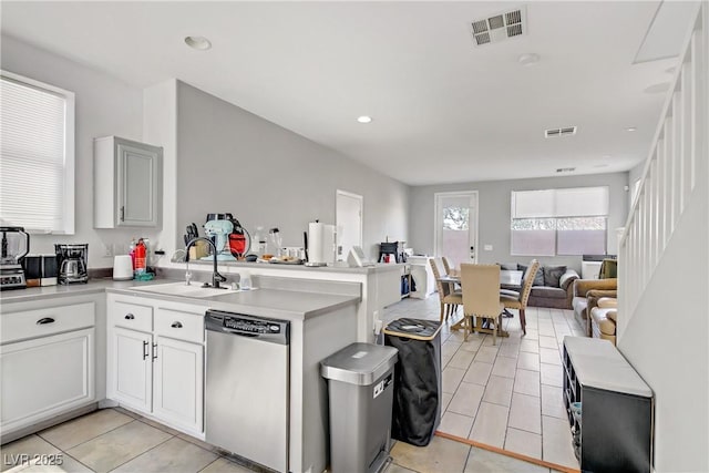 5324 Pendergrass St, North Las Vegas, NV 89081 - kitchen featuring dishwasher, open floor plan, light countertops, light tile patterned floors, and a peninsula