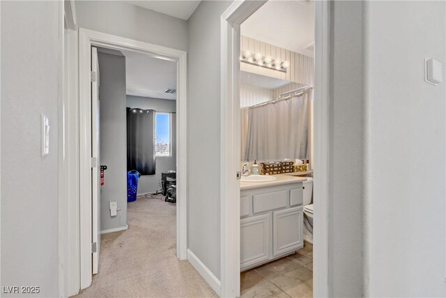 5324 Pendergrass St, North Las Vegas, NV 89081 - hall with baseboards and a sink