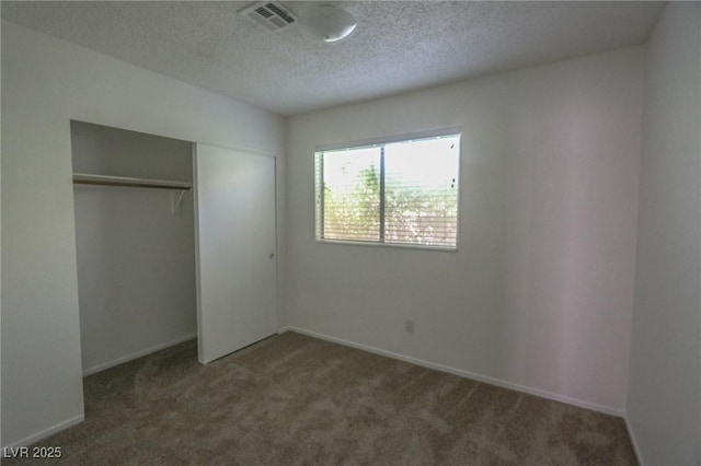 1349 Goldenglow Rd, Las Vegas, NV 89108 - unfurnished bedroom featuring carpet flooring, a textured ceiling, and a closet