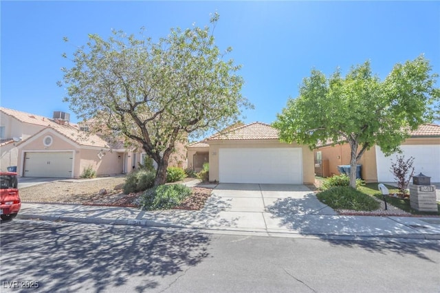 1349 Goldenglow Rd, Las Vegas, NV 89108 - obstructed view of property featuring an attached garage, concrete driveway, stucco siding, and a tiled roof