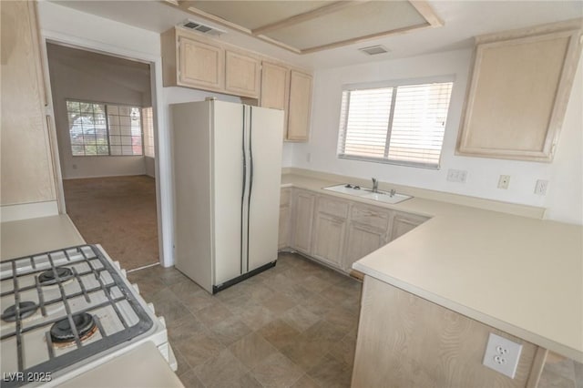 1349 Goldenglow Rd, Las Vegas, NV 89108 - kitchen featuring white appliances, light brown cabinets, and light countertops