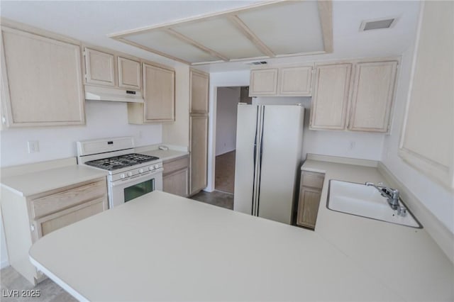 1349 Goldenglow Rd, Las Vegas, NV 89108 - kitchen featuring white appliances, under cabinet range hood, light brown cabinets, light countertops, and a peninsula