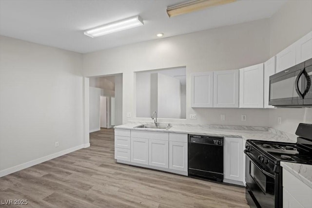 905 Harp Way N, Las Vegas, NV 89032 - kitchen featuring black appliances, white cabinetry, light wood-style floors, light stone counters, and recessed lighting