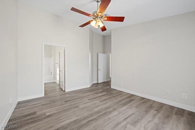 905 Harp Way N, Las Vegas, NV 89032 - spare room with wood finished floors, a ceiling fan, and a high ceiling