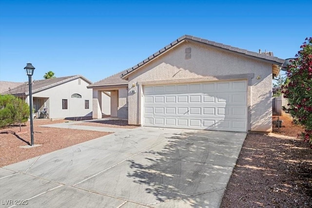 905 Harp Way N, Las Vegas, NV 89032 - ranch-style home with stucco siding, a garage, driveway, and a tiled roof