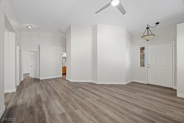 905 Harp Way N, Las Vegas, NV 89032 - unfurnished living room with wood finished floors, a ceiling fan, and vaulted ceiling
