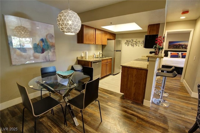 4200 S Valley View Blvd Unit 1035, Las Vegas, NV 89103 - dining space featuring wood finished floors and a skylight