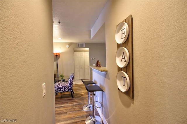 4200 S Valley View Blvd Unit 1035, Las Vegas, NV 89103 - hall with a textured wall and dark wood-type flooring