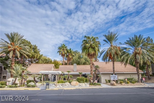 4200 S Valley View Blvd Unit 1035, Las Vegas, NV 89103 - view of front of home featuring a tile roof, stucco siding, a chimney, and a pergola