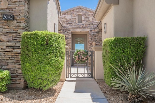 3042 Soft Horizon Way, Las Vegas, NV 89135 - entrance to property with stucco siding, stone siding, and a gate
