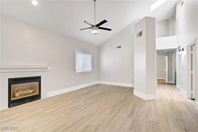 2925 Wigwam Pkwy Unit 1021, Henderson, NV 89074 - unfurnished living room featuring high vaulted ceiling, wood finished floors, ceiling fan, a glass covered fireplace, and recessed lighting