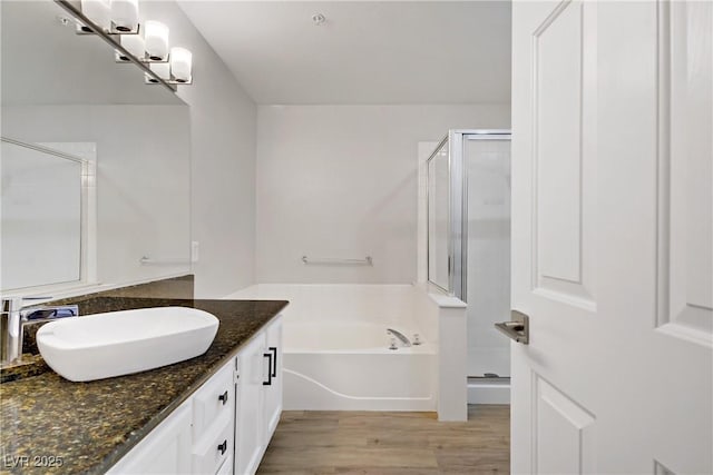 2925 Wigwam Pkwy Unit 1021, Henderson, NV 89074 - bathroom featuring vanity, a stall shower, a bath, and wood finished floors
