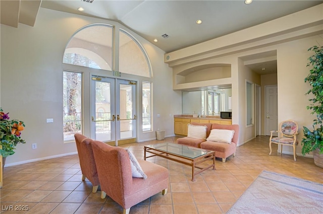 2925 Wigwam Pkwy Unit 1021, Henderson, NV 89074 - living room with french doors, plenty of natural light, light tile patterned floors, recessed lighting, and lofted ceiling