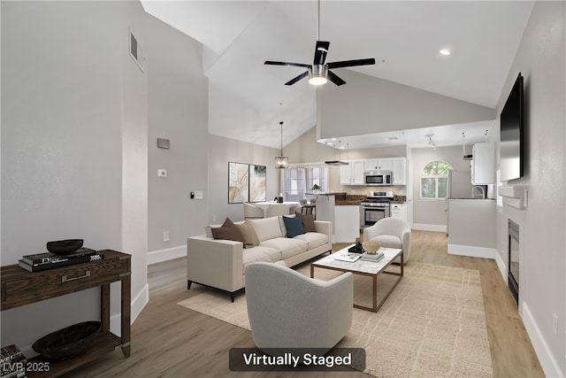 2925 Wigwam Pkwy Unit 1021, Henderson, NV 89074 - living room featuring high vaulted ceiling, light wood finished floors, and a ceiling fan