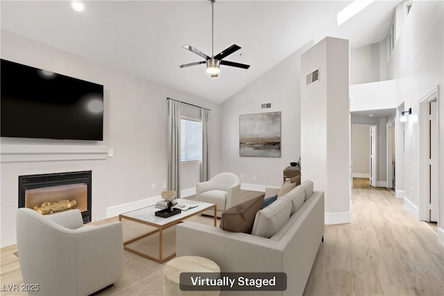 2925 Wigwam Pkwy Unit 1021, Henderson, NV 89074 - living area featuring ceiling fan, light wood finished floors, a glass covered fireplace, high vaulted ceiling, and recessed lighting