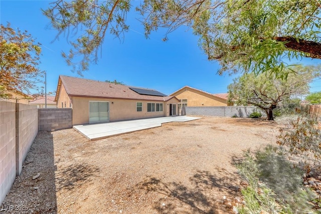 3604 Cantura Crest Ct, North Las Vegas, NV 89031 - rear view of house with a patio area, solar panels, stucco siding, and a fenced backyard