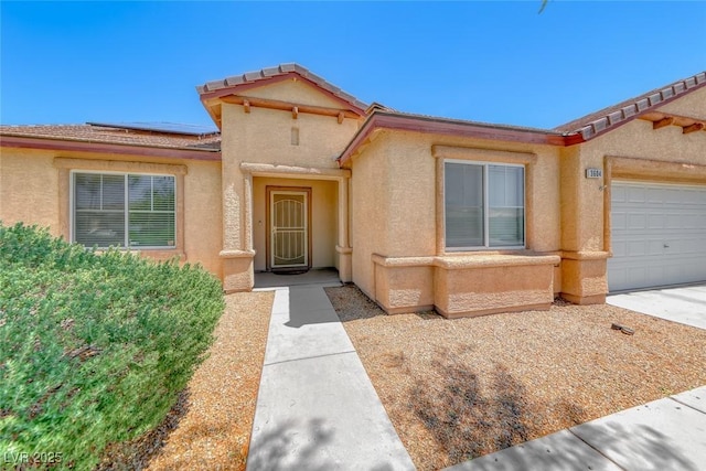 3604 Cantura Crest Ct, North Las Vegas, NV 89031 - entrance to property with roof mounted solar panels, stucco siding, and a garage