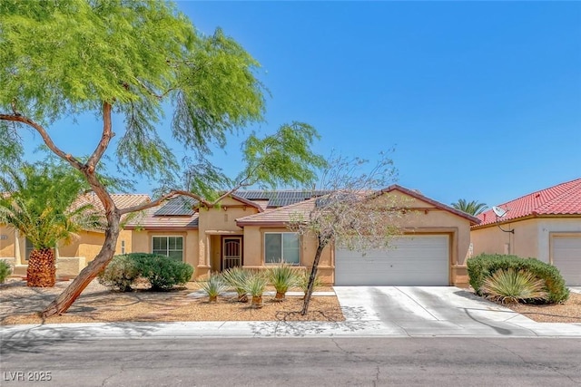 3604 Cantura Crest Ct, North Las Vegas, NV 89031 - view of front of home with an attached garage, a tiled roof, roof mounted solar panels, and stucco siding