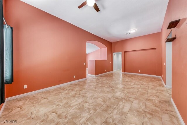 3604 Cantura Crest Ct, North Las Vegas, NV 89031 - empty room with ceiling fan, arched walkways, and marble look tile flooring