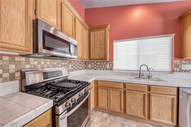 3604 Cantura Crest Ct, North Las Vegas, NV 89031 - kitchen featuring appliances with stainless steel finishes, decorative backsplash, and tile countertops