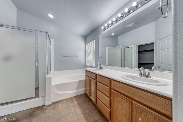 3604 Cantura Crest Ct, North Las Vegas, NV 89031 - bathroom with a stall shower, double vanity, a bath, and a walk in closet