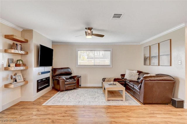 925 Alan Shepard St, Las Vegas, NV 89145 - living area featuring crown molding, a glass covered fireplace, light wood-type flooring, and a ceiling fan