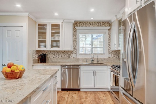 925 Alan Shepard St, Las Vegas, NV 89145 - kitchen with appliances with stainless steel finishes, ornamental molding, white cabinets, backsplash, and glass insert cabinets