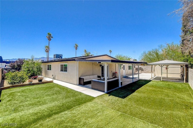 925 Alan Shepard St, Las Vegas, NV 89145 - rear view of house featuring an outdoor hangout area, a fenced backyard, a patio, stucco siding, and an outdoor structure