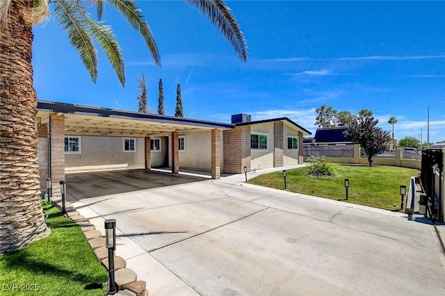 925 Alan Shepard St, Las Vegas, NV 89145 - ranch-style house with stucco siding, concrete driveway, and an attached carport
