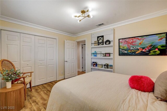 925 Alan Shepard St, Las Vegas, NV 89145 - bedroom featuring crown molding, light wood-style floors, and a closet