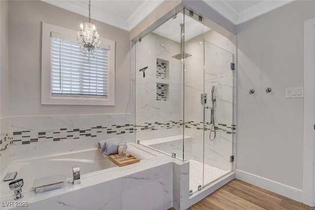 925 Alan Shepard St, Las Vegas, NV 89145 - bathroom with a garden tub, a marble finish shower, a chandelier, wood finished floors, and crown molding