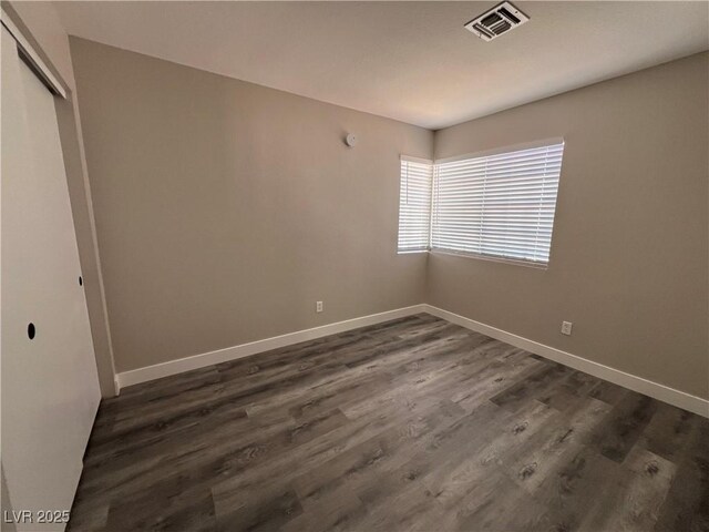 3238 Canyon Terrace Dr, Laughlin, NV 89029 - unfurnished bedroom featuring a closet and dark wood-type flooring