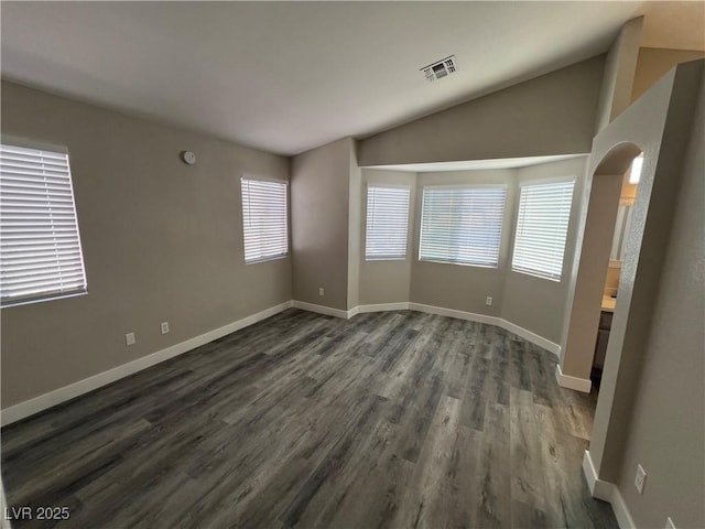 3238 Canyon Terrace Dr, Laughlin, NV 89029 - empty room with dark wood-type flooring, arched walkways, and lofted ceiling
