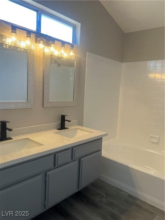 3238 Canyon Terrace Dr, Laughlin, NV 89029 - full bath with double vanity, wood finished floors, and shower / bath combination