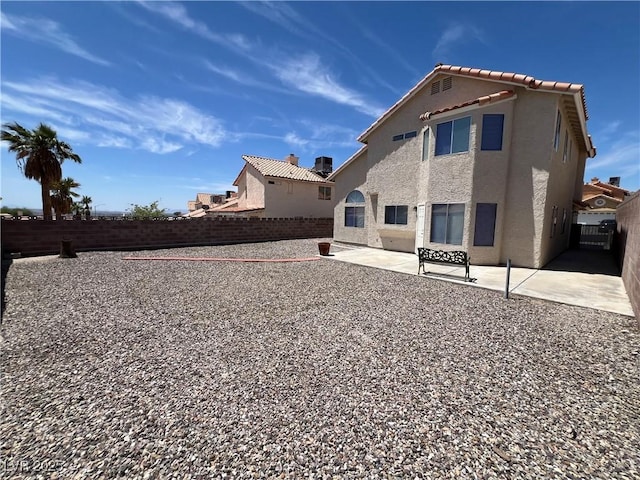3238 Canyon Terrace Dr, Laughlin, NV 89029 - back of house with stucco siding, a patio area, a fenced backyard, and a tile roof