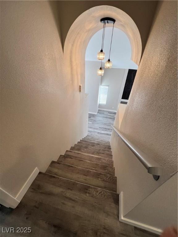 3238 Canyon Terrace Dr, Laughlin, NV 89029 - staircase featuring wood finished floors, arched walkways, and a textured wall