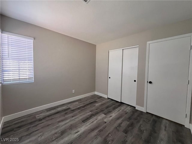 3238 Canyon Terrace Dr, Laughlin, NV 89029 - unfurnished bedroom with dark wood-type flooring and a closet