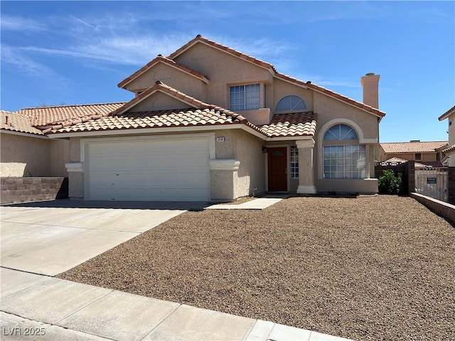 3238 Canyon Terrace Dr, Laughlin, NV 89029 - mediterranean / spanish-style house featuring a garage, stucco siding, concrete driveway, and a tiled roof