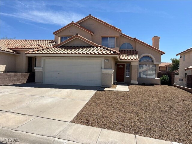 3238 Canyon Terrace Dr, Laughlin, NV 89029 - mediterranean / spanish-style home with a garage, concrete driveway, stucco siding, and a tiled roof