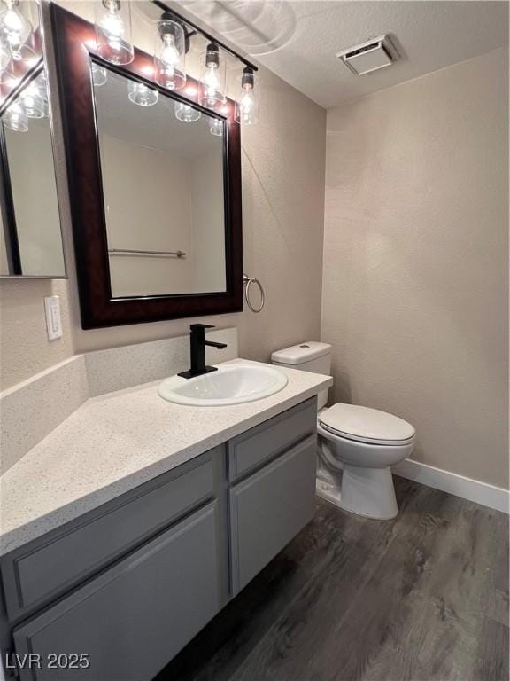 3238 Canyon Terrace Dr, Laughlin, NV 89029 - bathroom with wood finished floors, vanity, and a textured ceiling